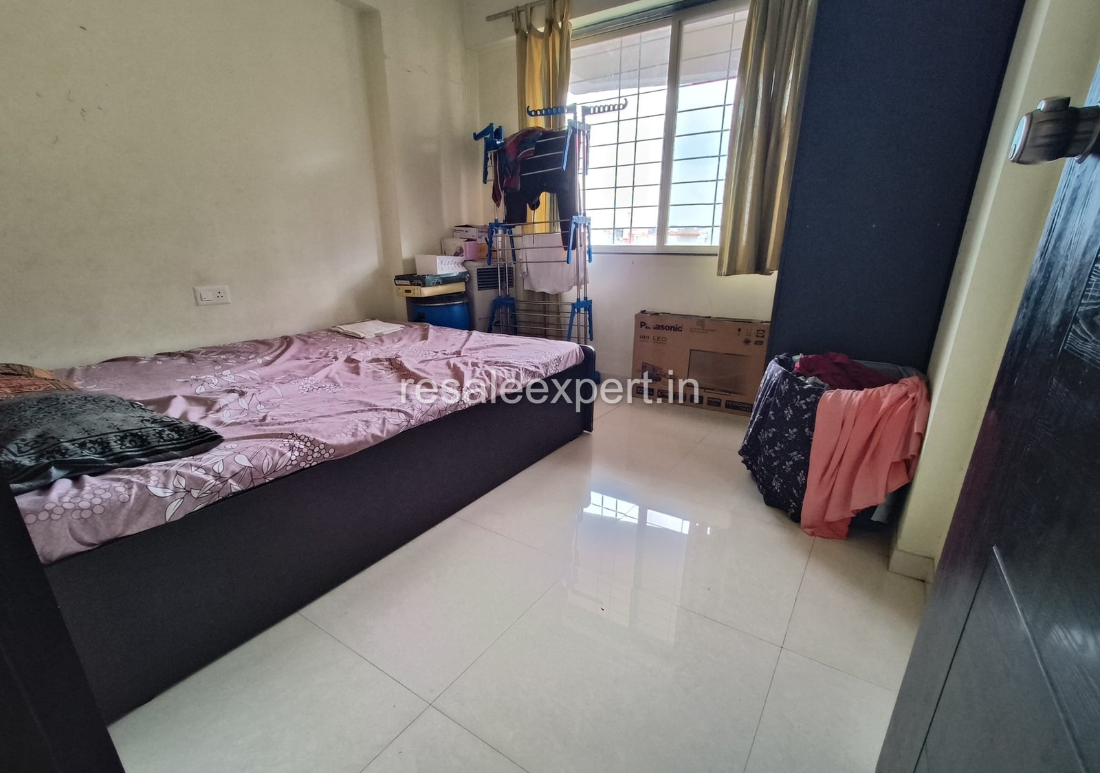 Cozy bedroom with window view in Rahatani 2 BHK Flat with Immediate Possession
