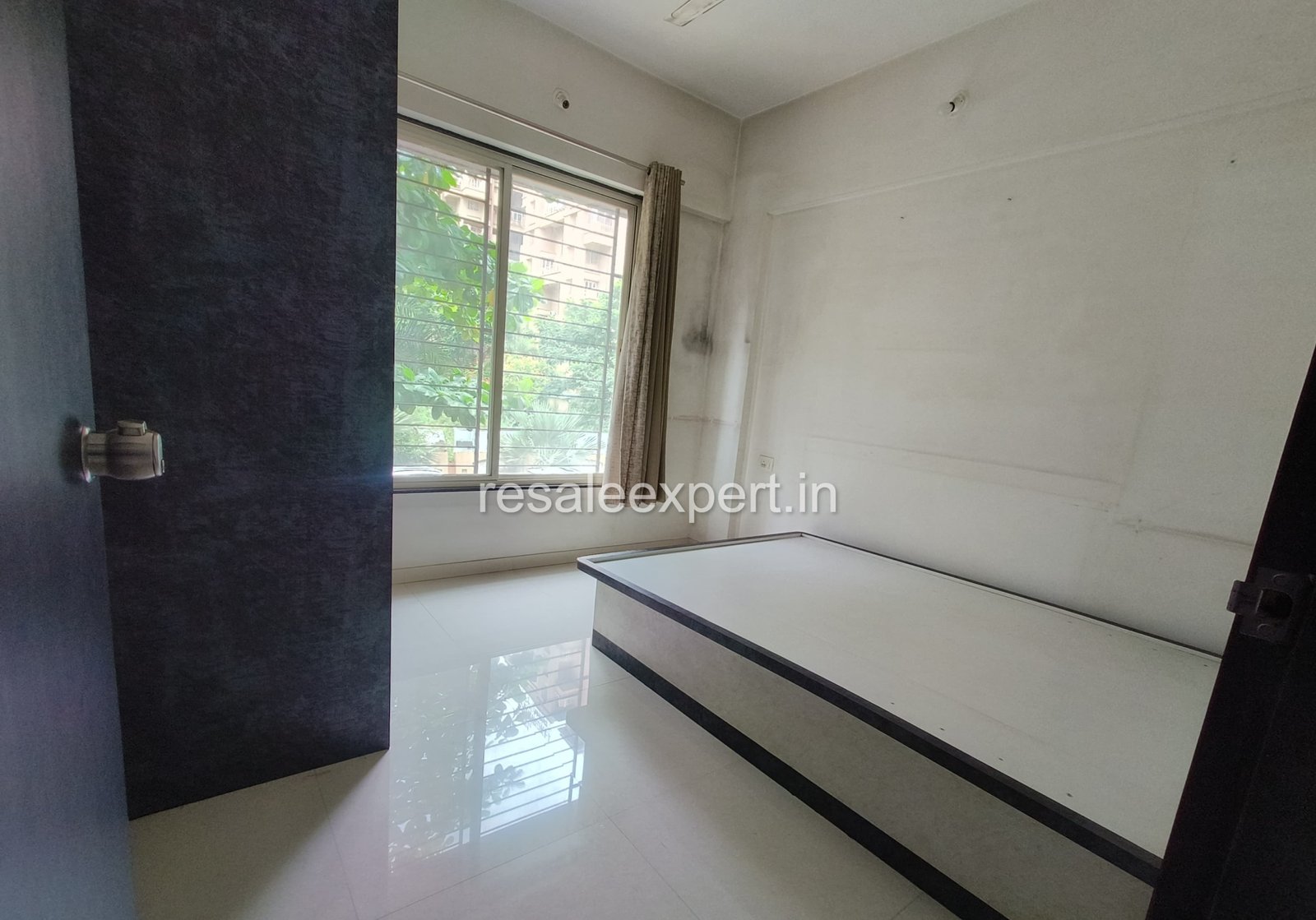 Well-lit bedroom with wardrobes in 2 BHK flat in Rahatani with immediate possession