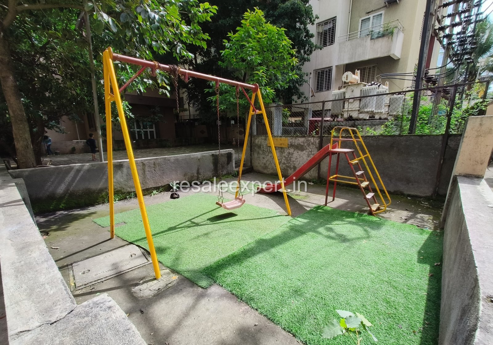 Well-maintained children’s play area near garden in 1 BHK project